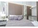 Well-appointed bedroom features an accent wall, a modern walk-in closet, and a stylish design at 10443 Ebb Tide Ln, Orlando, FL 32821