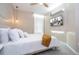 Inviting bedroom featuring a ceiling fan, wall-mounted TV, and elegant pendant lighting at 10443 Ebb Tide Ln, Orlando, FL 32821