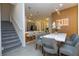 Contemporary dining area with pendant lights, stairs, and a modern open kitchen at 10443 Ebb Tide Ln, Orlando, FL 32821