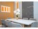 Contemporary dining room featuring a white table, seating for six, and modern light fixture at 10443 Ebb Tide Ln, Orlando, FL 32821