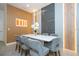 Bright dining room with a white table, seating for six, and contemporary design elements at 10443 Ebb Tide Ln, Orlando, FL 32821