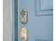 Close-up of a light blue door with a digital keypad and ornate accents at 10443 Ebb Tide Ln, Orlando, FL 32821