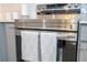 A detailed view of the kitchen's stainless steel oven with decorative towels at 10443 Ebb Tide Ln, Orlando, FL 32821