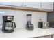 A variety of small appliances including a coffee maker, toaster, and blender sit on a quartz countertop at 10443 Ebb Tide Ln, Orlando, FL 32821