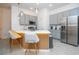 Well-equipped kitchen featuring gray cabinets, stainless steel appliances, and pendant lighting at 10443 Ebb Tide Ln, Orlando, FL 32821