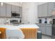 Stylish kitchen with gray cabinetry, stainless steel appliances, and a modern backsplash at 10443 Ebb Tide Ln, Orlando, FL 32821