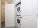 Convenient in-unit laundry closet with stacked washer and dryer, maximizing space efficiency at 10443 Ebb Tide Ln, Orlando, FL 32821