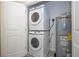 Efficient laundry setup with stacked washer/dryer and water heater in an organized closet at 10443 Ebb Tide Ln, Orlando, FL 32821