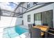 Relaxing screened-in pool area with an outdoor dining area for entertainment at 10443 Ebb Tide Ln, Orlando, FL 32821