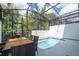 Inviting pool and outdoor dining area in a screened in patio at 10443 Ebb Tide Ln, Orlando, FL 32821