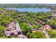 Aerial view of a lakeside community showcasing mature trees, a lake and red-tiled roofs at 1068 E Michigan St # A, Orlando, FL 32806