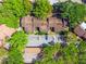 Aerial view of a community with mature trees, parking and well-maintained rooftops at 1068 E Michigan St # A, Orlando, FL 32806