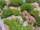 Aerial view of a lakeside community with mature trees and on-site parking at 1068 E Michigan St # A, Orlando, FL 32806