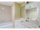 Bathroom featuring shower and tub, spacious vanity, and neutral colored paint at 1068 E Michigan St # A, Orlando, FL 32806