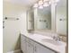 Bathroom featuring a double vanity with framed mirrors and white cabinetry at 1068 E Michigan St # A, Orlando, FL 32806
