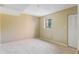 Bedroom featuring neutral colored walls, carpet, a window for natural light, and a closet at 1068 E Michigan St # A, Orlando, FL 32806