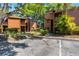 Exterior view of a two-story condo with mature landscaping and ample parking at 1068 E Michigan St # A, Orlando, FL 32806