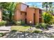 Exterior view of a two-story condo with mature landscaping and a well-maintained lawn at 1068 E Michigan St # A, Orlando, FL 32806