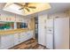 Spacious kitchen area with white cabinets, laminate counters, and stainless steel dishwasher at 1068 E Michigan St # A, Orlando, FL 32806