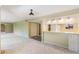 Bright, carpeted living room featuring a pass through to the kitchen and neutral decor at 1068 E Michigan St # A, Orlando, FL 32806
