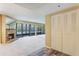 Bright living room featuring a stone fireplace, large windows, and convenient closet space at 1068 E Michigan St # A, Orlando, FL 32806