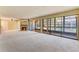 Open-concept living room with a stone fireplace and large windows providing natural light at 1068 E Michigan St # A, Orlando, FL 32806