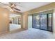 Bright living room featuring a slider to a screened patio and neutral carpeting at 1068 E Michigan St # A, Orlando, FL 32806