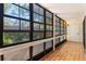 Sunroom filled with natural light from numerous windows and unique tile flooring at 1068 E Michigan St # A, Orlando, FL 32806