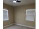 Cozy bedroom featuring tile floors, a ceiling fan, and natural light through windows at 1121 Santa Anita St, Orlando, FL 32808