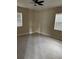 Comfortable bedroom with tile flooring, a ceiling fan, and windows for natural light at 1121 Santa Anita St, Orlando, FL 32808