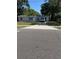 Charming single-story home featuring a long driveway and a well-maintained front lawn, set under mature trees at 1121 Santa Anita St, Orlando, FL 32808