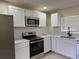 Stylish kitchen with stainless steel appliances, white cabinetry, and modern finishes at 1121 Santa Anita St, Orlando, FL 32808