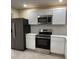 Modern kitchen with stainless steel appliances, white cabinets, and sleek countertops at 1121 Santa Anita St, Orlando, FL 32808