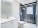 Modern bathroom featuring dark tile shower with glass enclosure, toilet, and vanity with sink at 11364 Cardiff Dr, Orlando, FL 32837