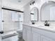 Bright bathroom featuring a double sink vanity, modern fixtures, and a glass enclosed shower with marble-style tiling at 11364 Cardiff Dr, Orlando, FL 32837