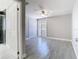 Bright bedroom with wood-look tile floors, ceiling fan, closet, and view into the bathroom at 11364 Cardiff Dr, Orlando, FL 32837