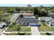 Aerial view of a well-maintained single-story home with a green lawn and long driveway at 11364 Cardiff Dr, Orlando, FL 32837