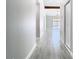 Hallway with tile flooring that leads to a living area with sliding glass doors to the pool at 11364 Cardiff Dr, Orlando, FL 32837