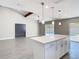 Open-concept kitchen and living area with island, perfect for entertaining and modern living; overlooks the pool at 11364 Cardiff Dr, Orlando, FL 32837