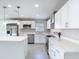 Bright kitchen with stainless steel appliances and white cabinetry at 11364 Cardiff Dr, Orlando, FL 32837