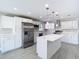Bright, modern kitchen features white cabinets, stainless steel appliances, and an island at 11364 Cardiff Dr, Orlando, FL 32837