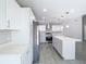 Modern kitchen featuring white cabinets, stainless steel appliances, and a center island with pendant lighting at 11364 Cardiff Dr, Orlando, FL 32837