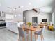 Open-concept living room with a modern kitchen island and vaulted ceiling at 11364 Cardiff Dr, Orlando, FL 32837