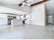 Open floor plan boasts a modern kitchen with stainless steel appliances and island at 11364 Cardiff Dr, Orlando, FL 32837