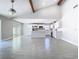 Bright open-concept living room with vaulted ceiling, tile flooring, and modern kitchen at 11364 Cardiff Dr, Orlando, FL 32837