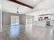 Bright living room with an open-concept layout connects to a white kitchen and dining area at 11364 Cardiff Dr, Orlando, FL 32837