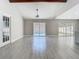 Bright living room with tile flooring and views of the pool through sliding glass doors at 11364 Cardiff Dr, Orlando, FL 32837