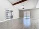 Large living area with vaulted ceiling, ceiling fan, and view of the pool area through sliding glass doors at 11364 Cardiff Dr, Orlando, FL 32837