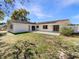 Expansive backyard with a concrete patio and well-maintained lawn, perfect for outdoor entertaining at 1155 Galahad Dr, Casselberry, FL 32707