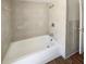 Bright bathroom featuring a white tile surround on the walls and a white tub at 1155 Galahad Dr, Casselberry, FL 32707